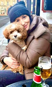 Ernie the Maltipoo cuddles with owner