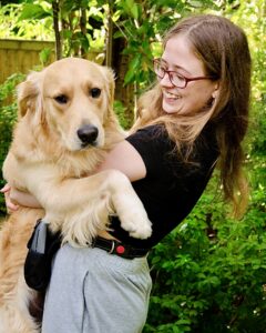 Ralph the Golden Retriever hugging owner