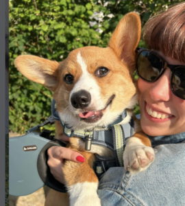 Happy Tan & White Corgi with owner